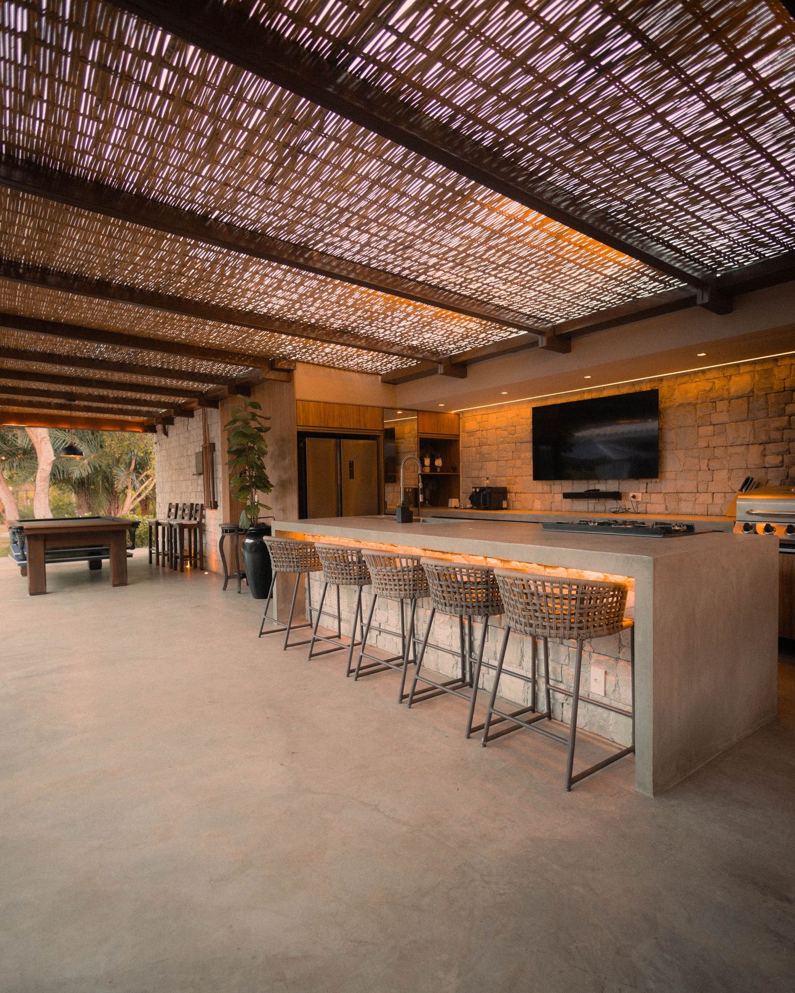 Outdoor kitchen and bar under a shade structure โ design inspiration