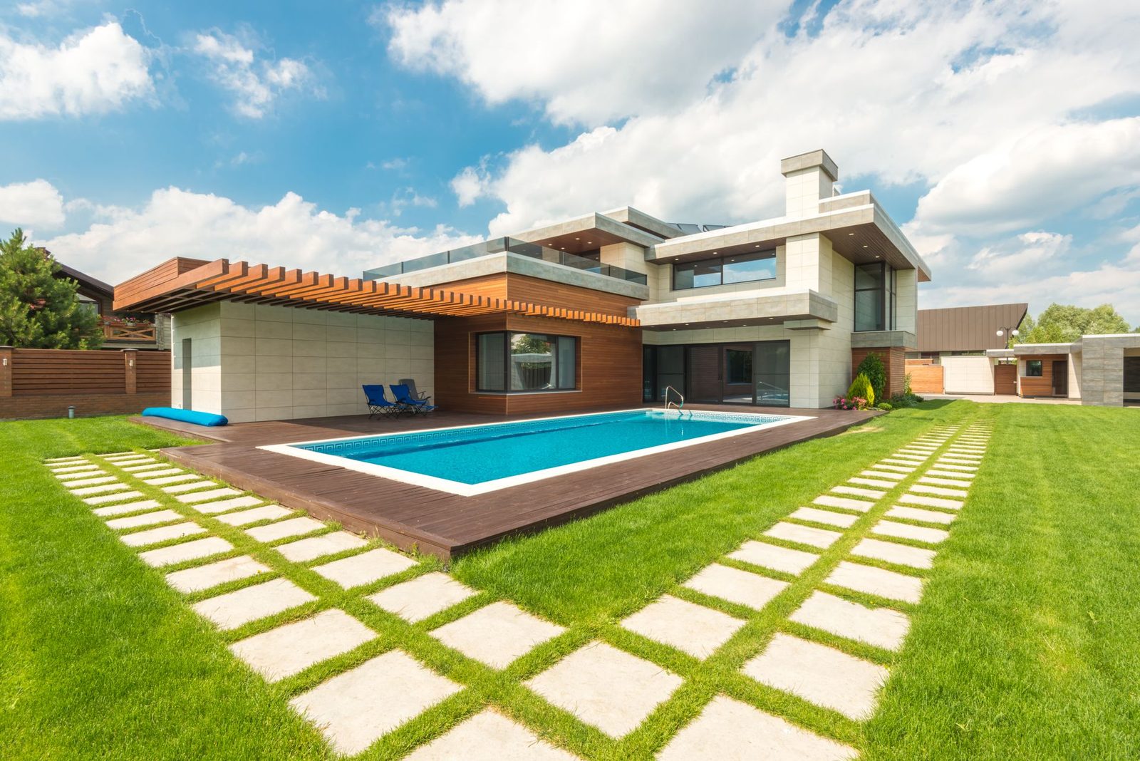Stepping-stone pavers leading across the lawn to the pool — design inspiration